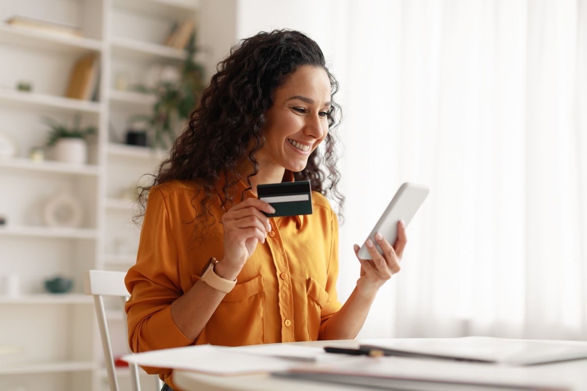 A tenant holding a credit card and paying rent online