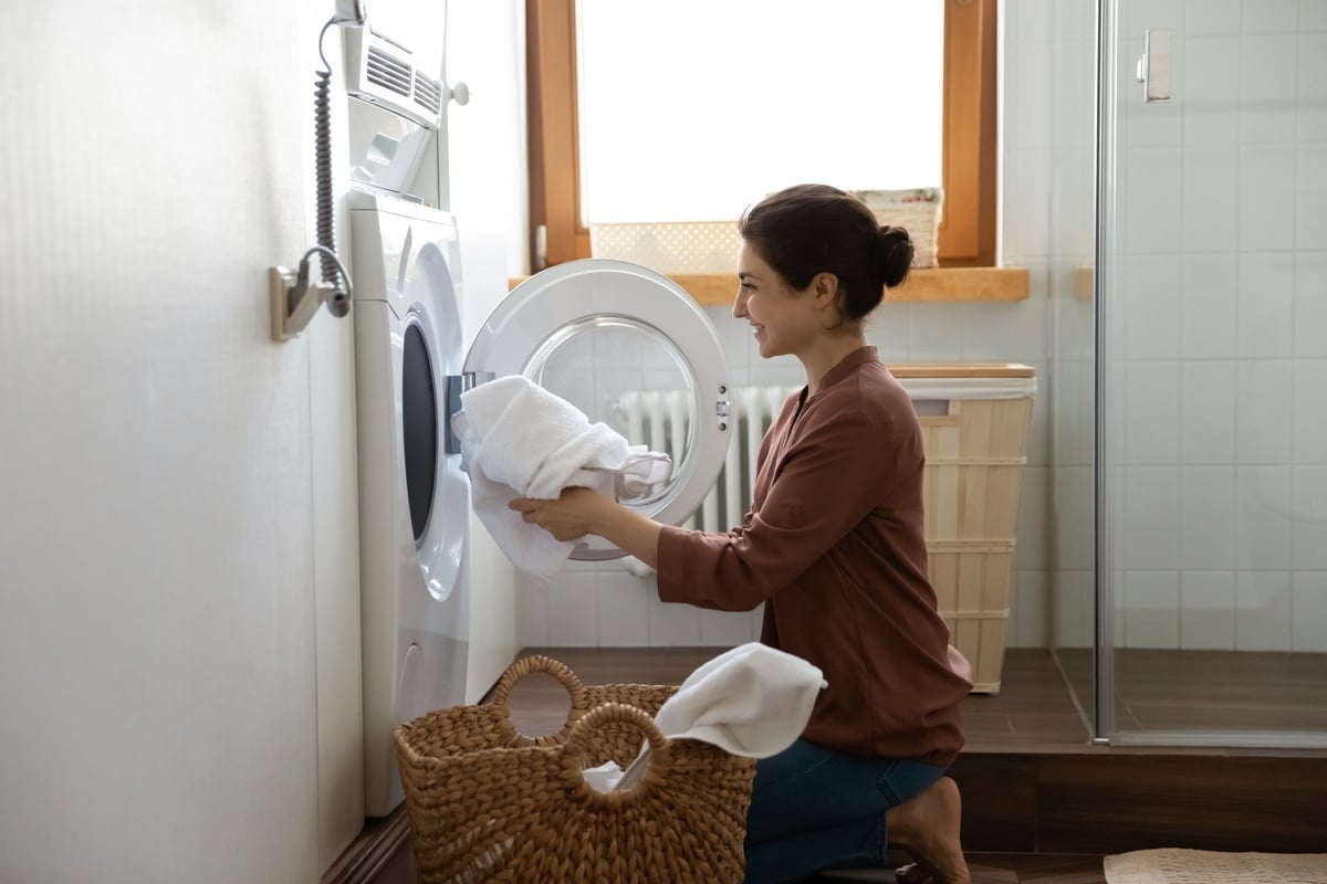 A woman loading a washer