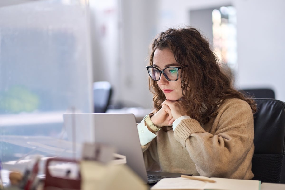 A woman looking at her laptop