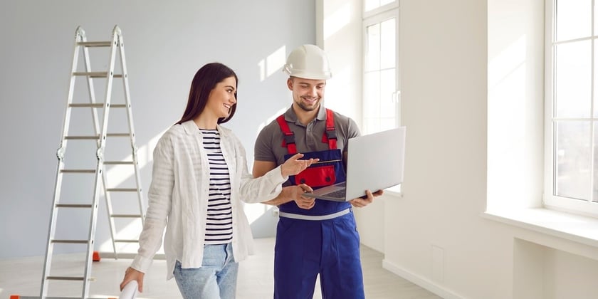 A woman speaking with a contractor