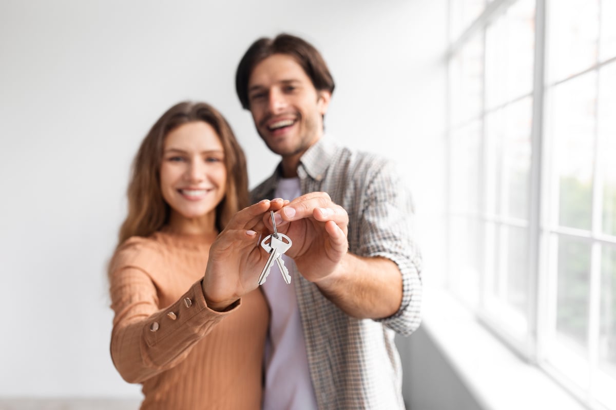 Happy tenants holding keys