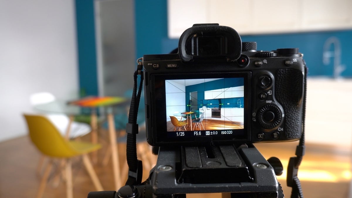 Real estate photographer taking pictures and videos at house in apartment living room