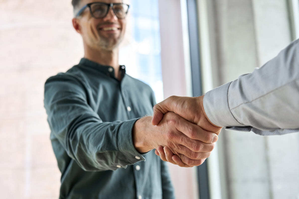 Two people shaking hands, vendor relationships concept