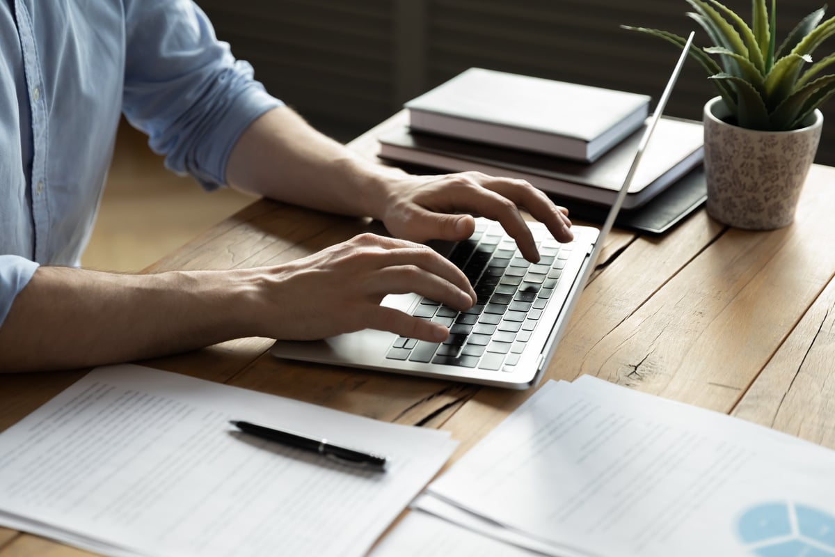 businessman using laptop, typing on keyboard