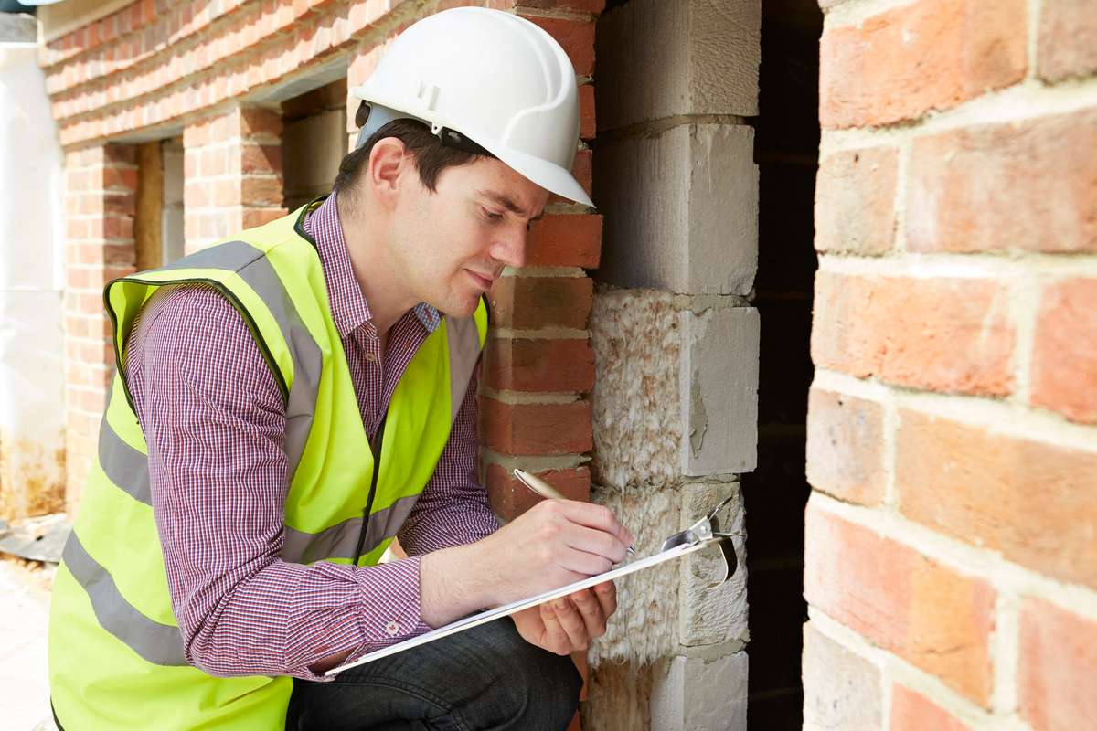 Architect Checking Insulation During House Construction