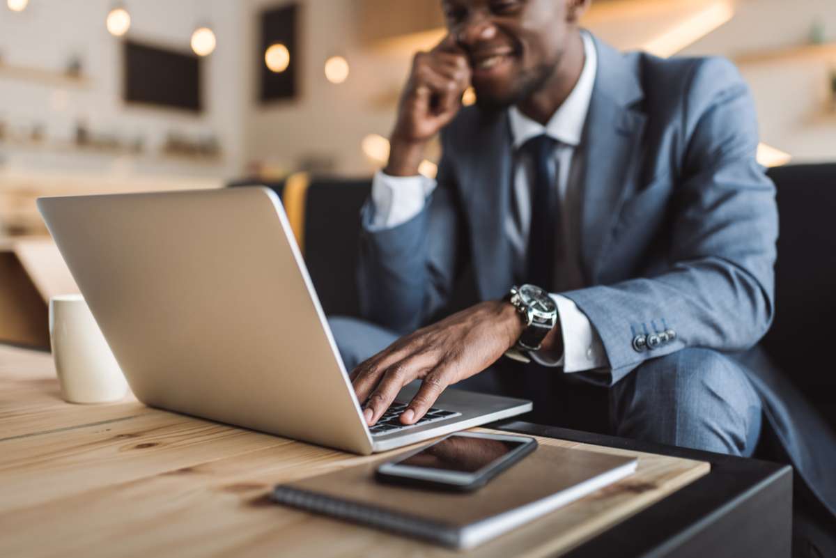 Businessman with laptop in cafe