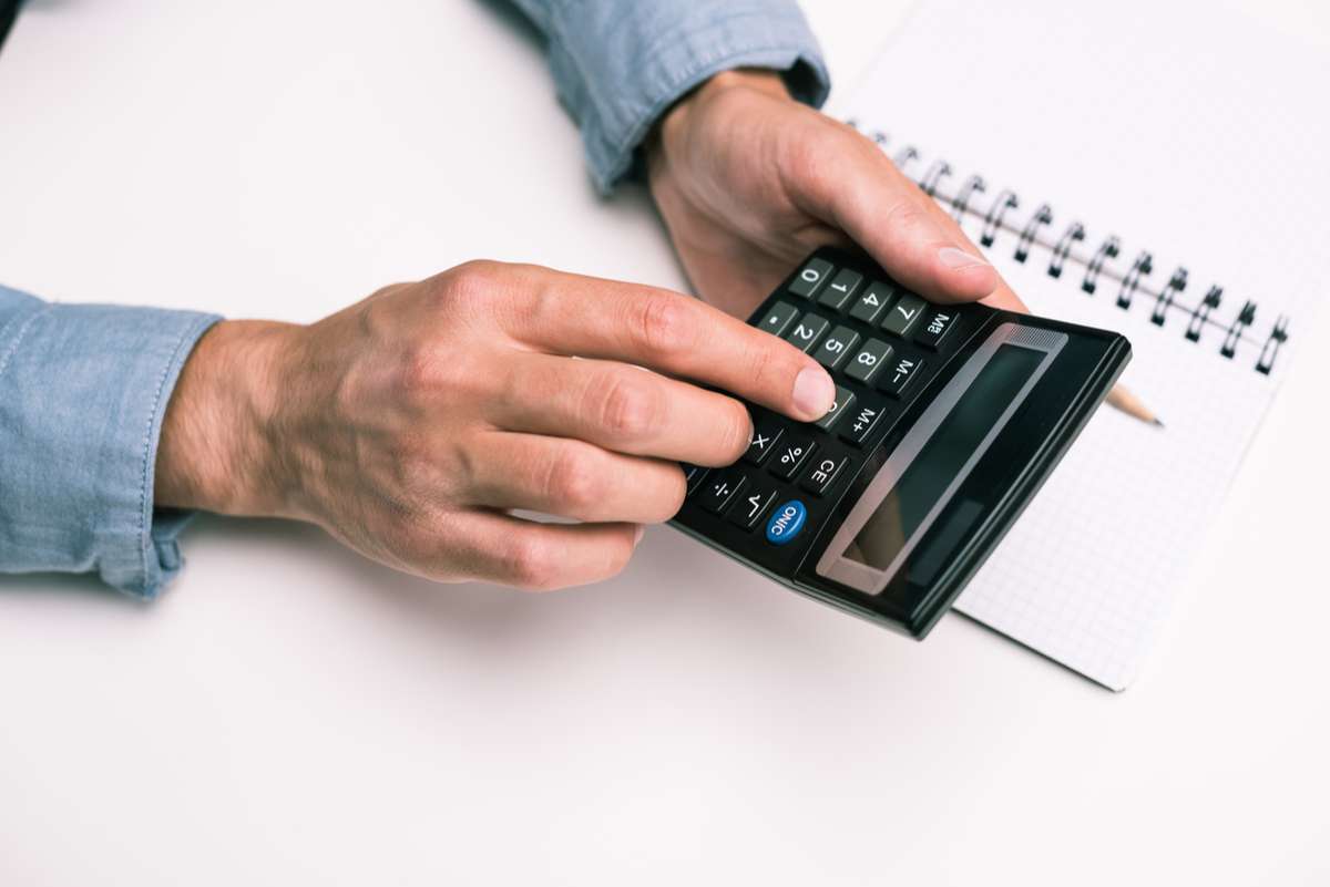 Hands with calculator and notepad