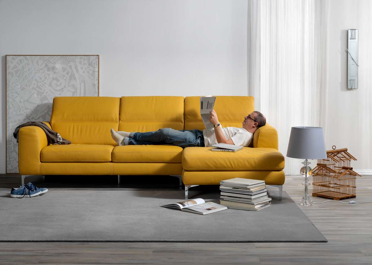 Single shot photo of a room with a sofa and person