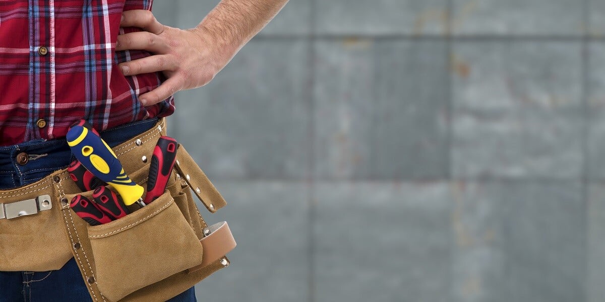 maintenance worker standing with tools